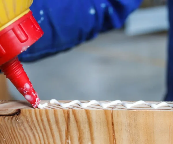 carpenter-at-work-crafting-using-glue-in-his-workshop-on-cut-wood-craftsman-working-glueing-.jpg